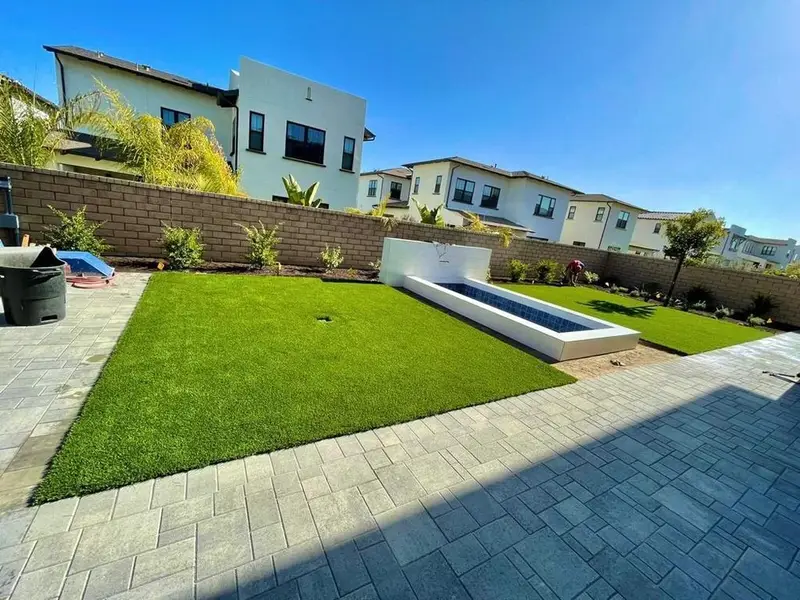 Artificial grass with concrete paver walkway in San Diego, CA by TurboSurfacing