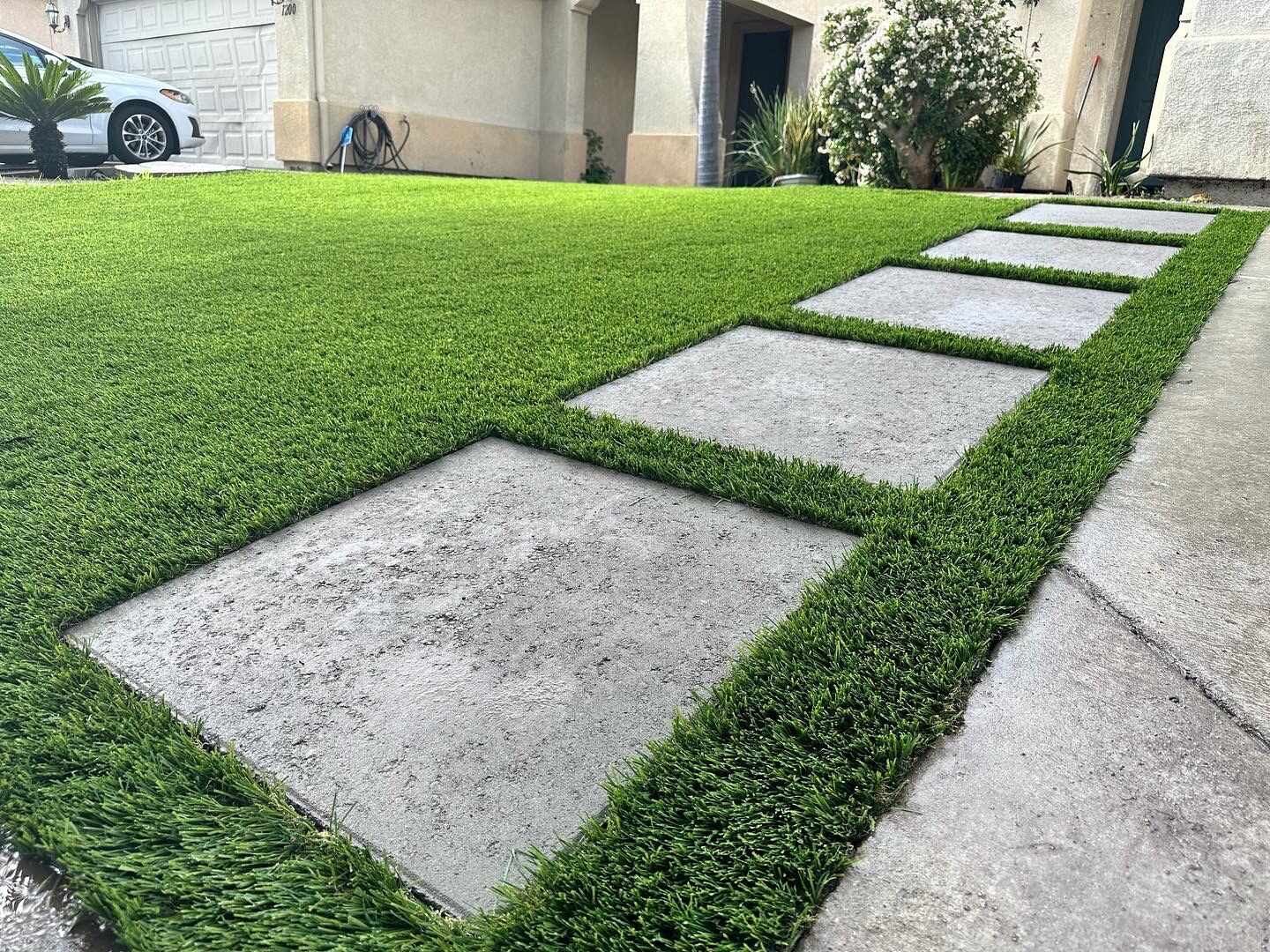 Artificial grass with concrete paver walkway in San Diego, CA by TurboSurfacing