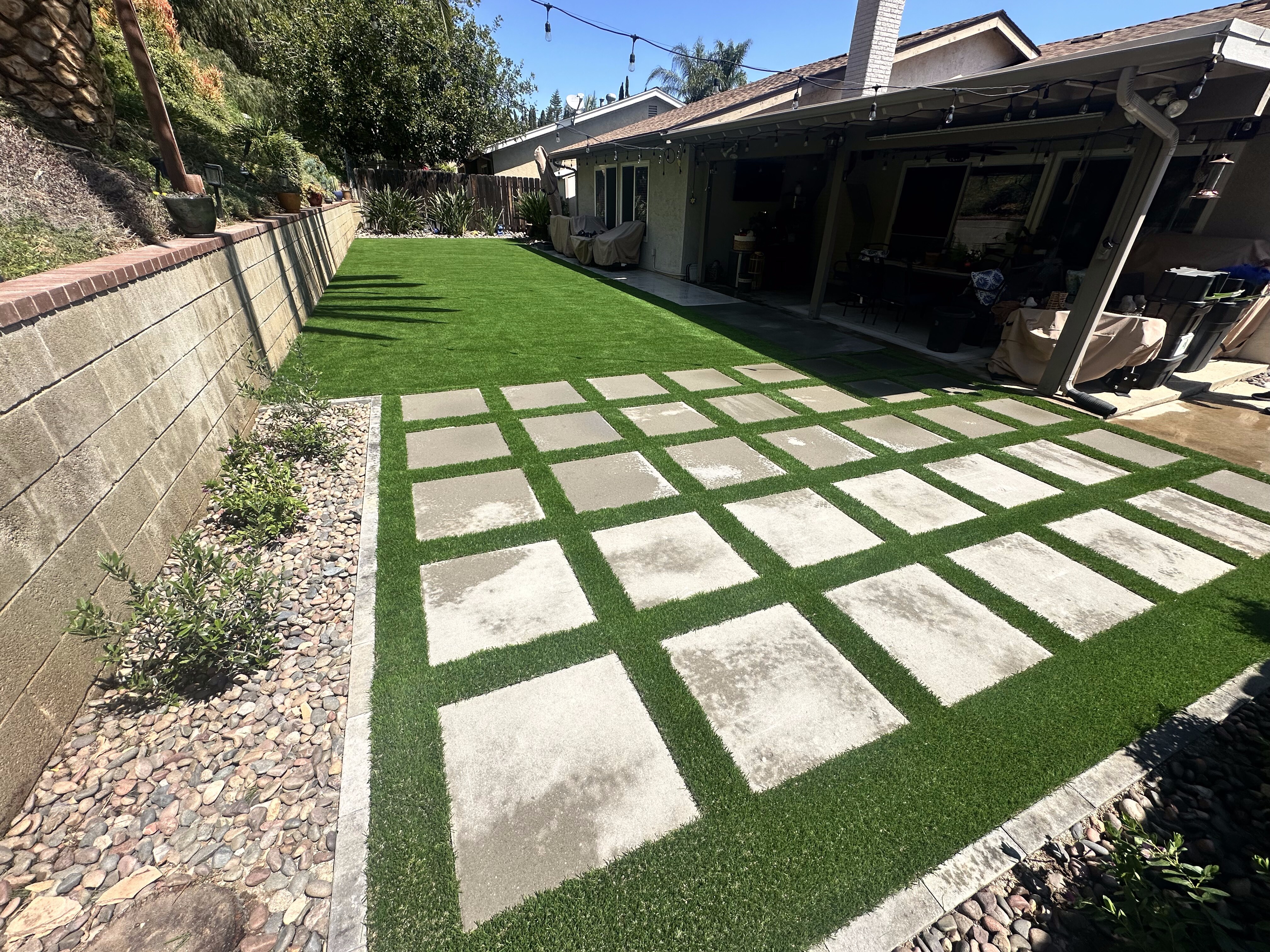 Artificial grass with concrete paver walkway in San Diego, CA by TurboSurfacing