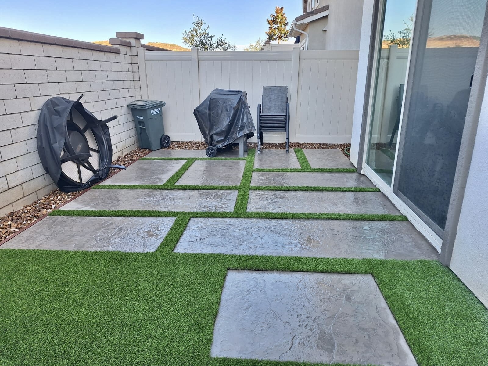 Artificial grass with concrete paver walkway in San Diego, CA by TurboSurfacing