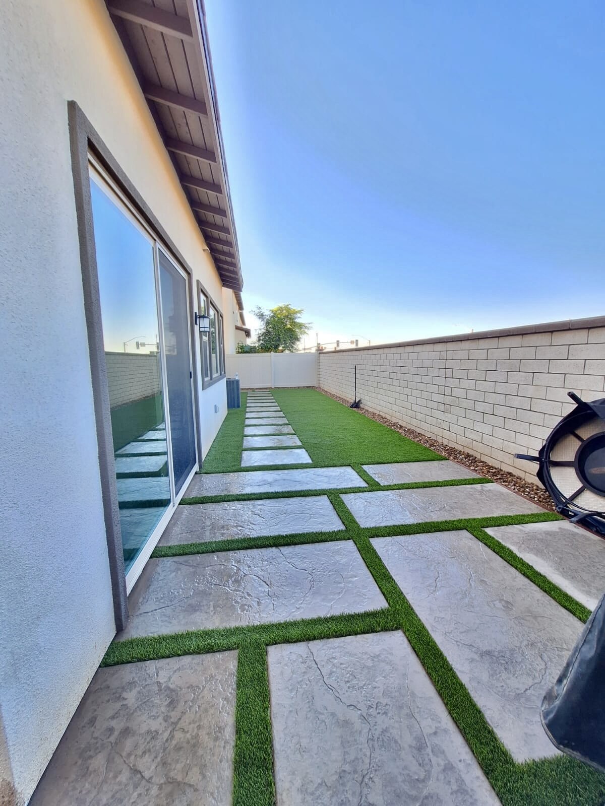 Artificial grass with concrete paver walkway in San Diego, CA by TurboSurfacing