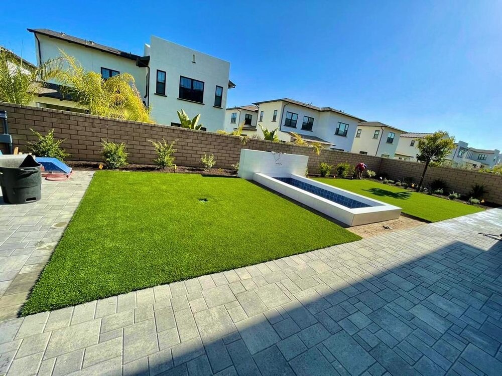Artificial grass with concrete paver walkway in San Diego, CA by TurboSurfacing