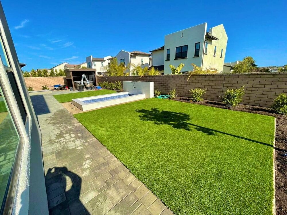 Artificial grass with concrete paver walkway in San Diego, CA by TurboSurfacing