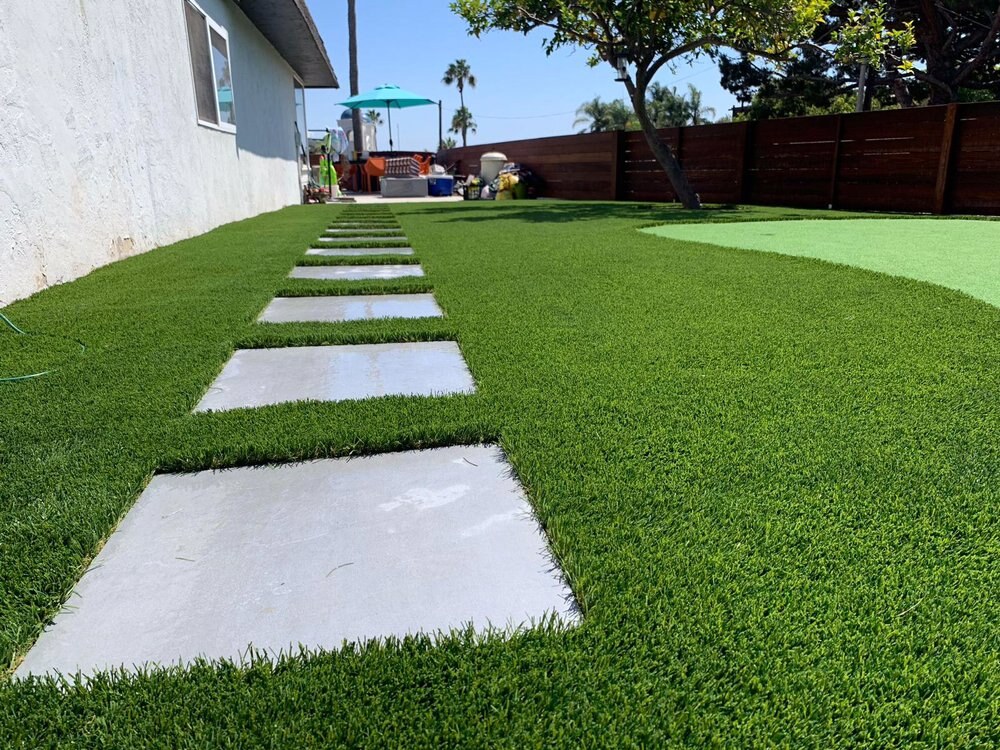 Artificial grass with concrete paver walkway in San Diego, CA by TurboSurfacing