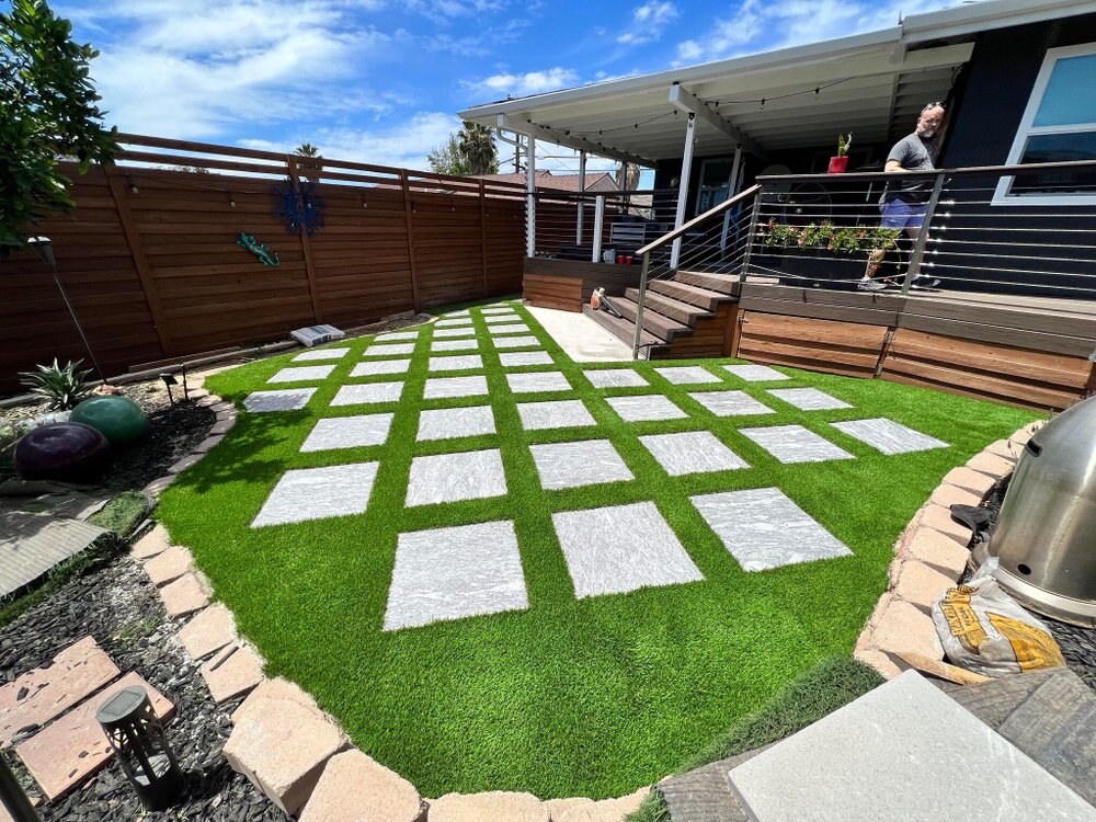 Artificial grass with concrete paver walkway in San Diego, CA by TurboSurfacing