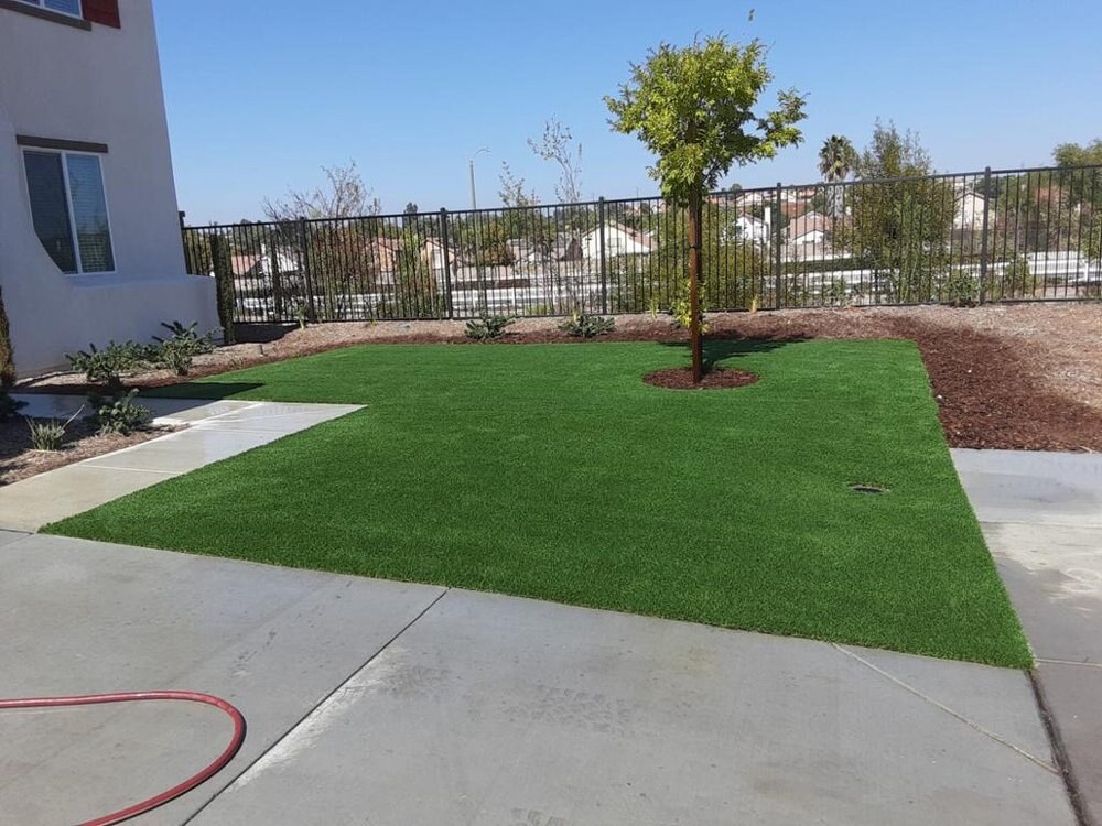 Artificial grass with concrete paver walkway in San Diego, CA by TurboSurfacing