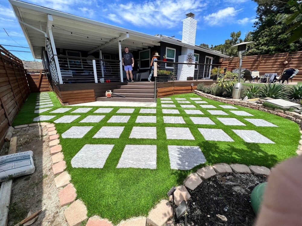 Artificial grass with concrete paver walkway in San Diego, CA by TurboSurfacing
